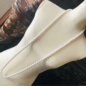 Knotted white plastic pearl bead necklace